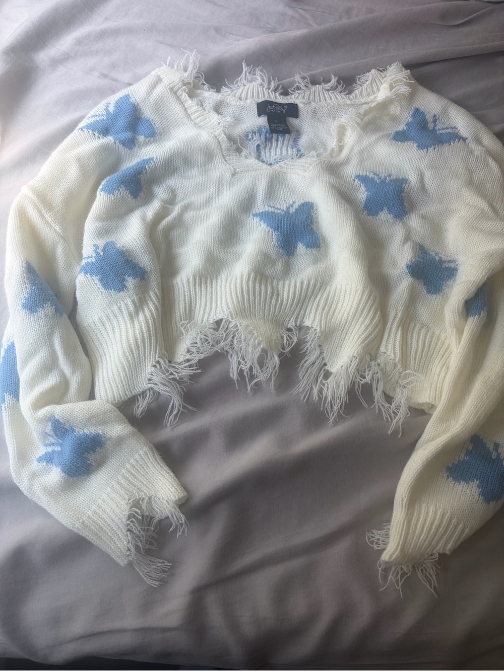 Cream Cropped Distressed Sweater with Blue Butterfly Design